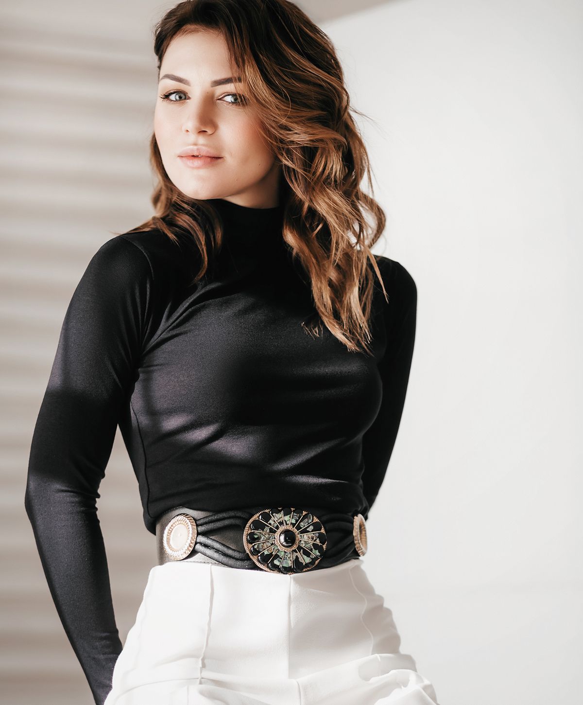 Woman smiling, holding oversized jeans, healthy lifestyle.