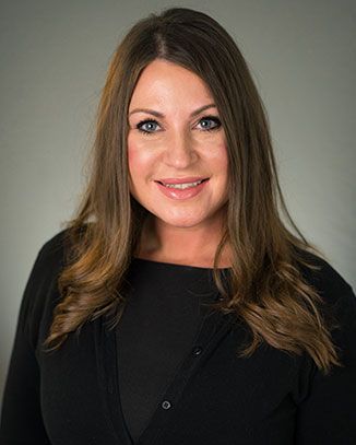 Professional headshot of a smiling woman.