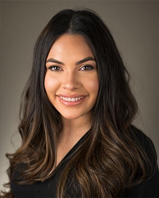Smiling woman with long dark hair.