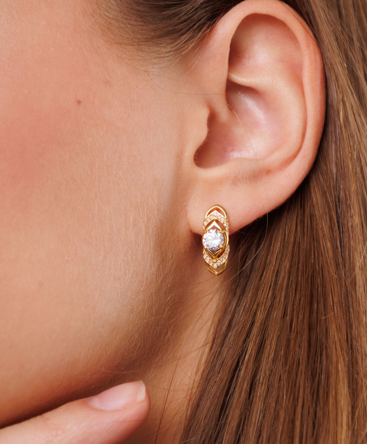 Gold earrings with a sparkling gemstone detail.