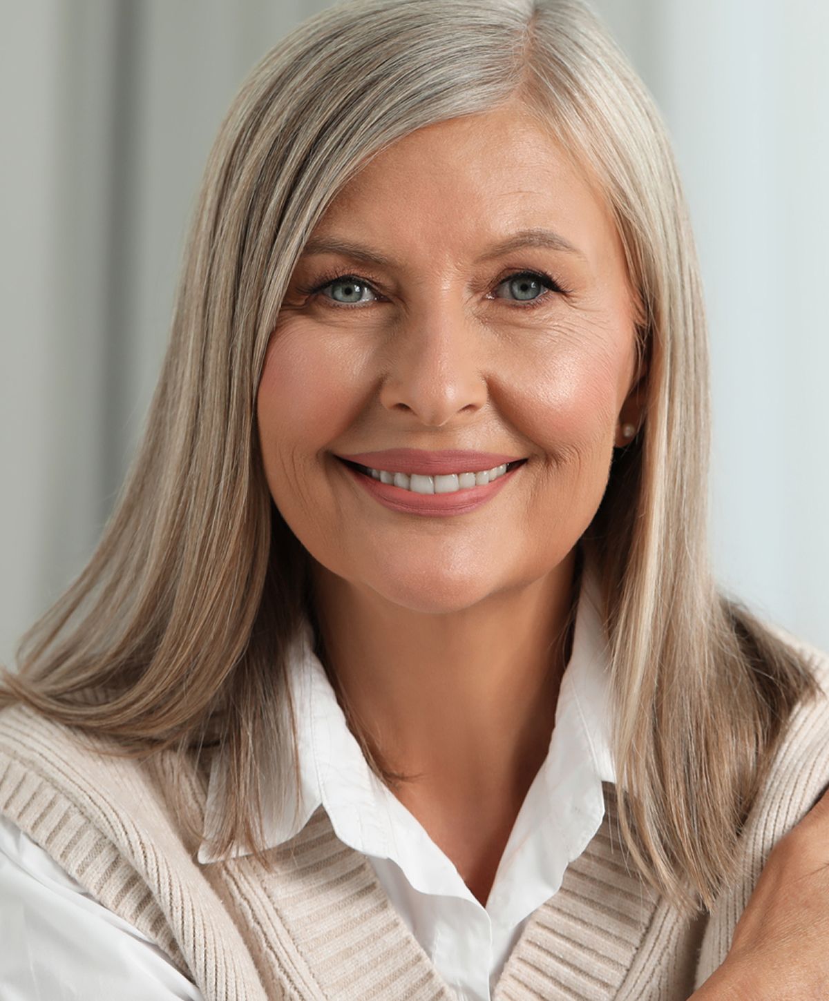 Smiling older woman with long, light hair.