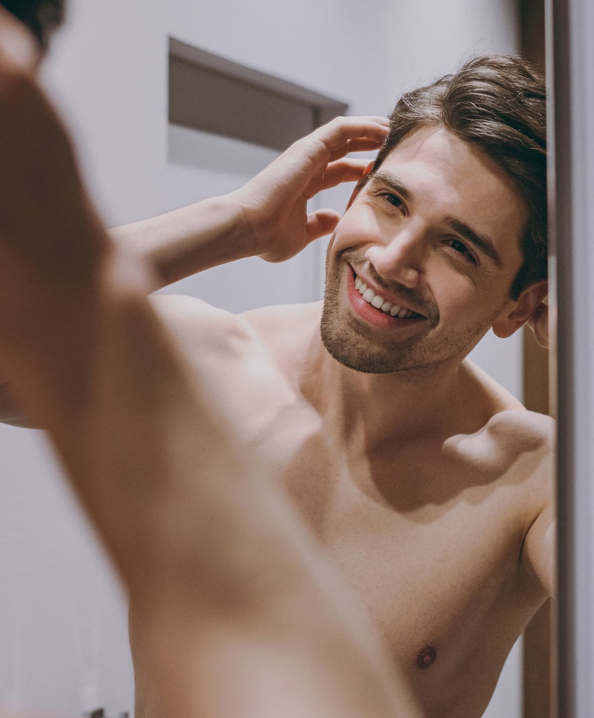 Smiling person enjoying their confidence in lingerie.