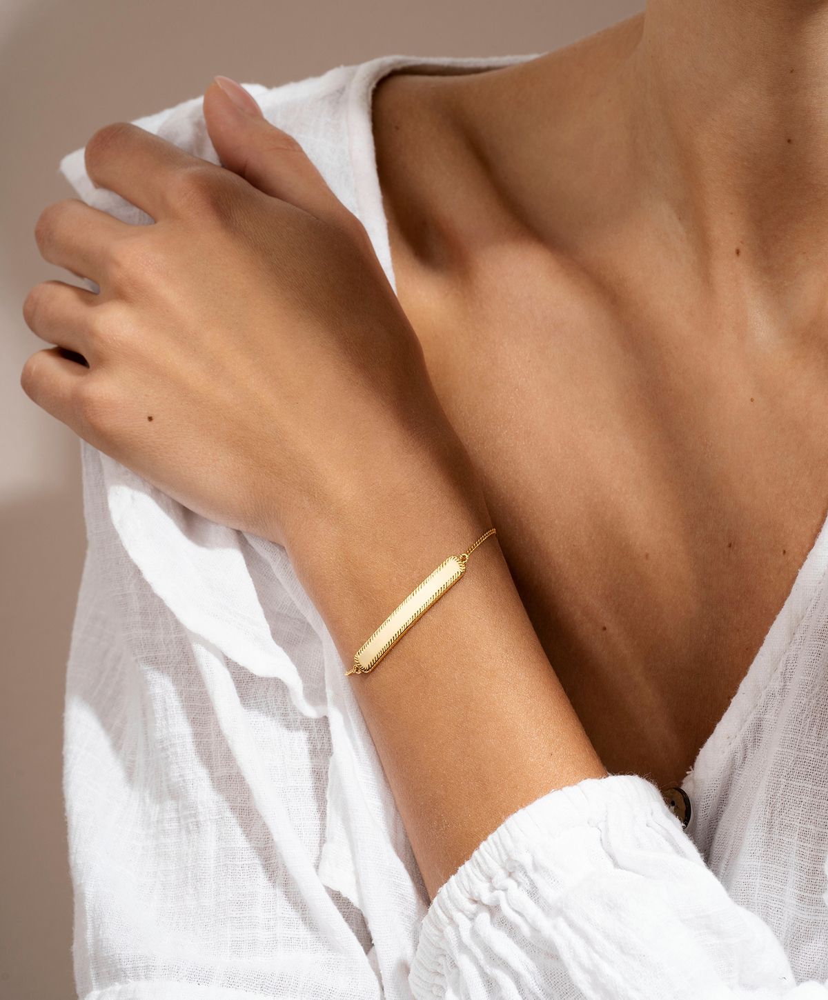 Elegant gold bracelet on a woman's wrist.