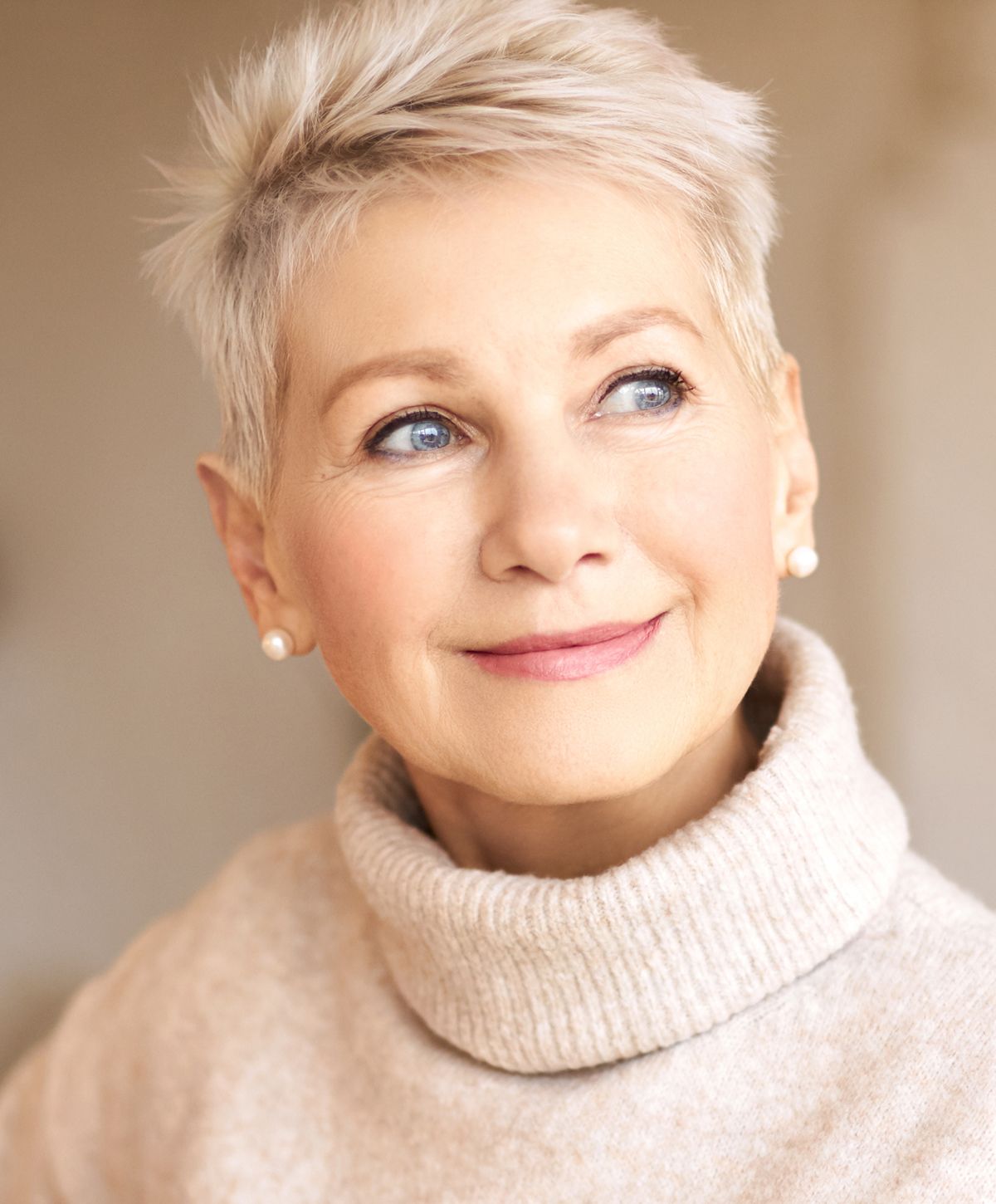 Smiling elderly woman with short, stylish hair.