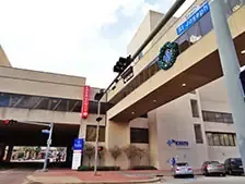 Shopping center with Starbucks and parking structure.