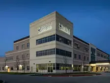 Modern healthcare facility exterior at dusk.