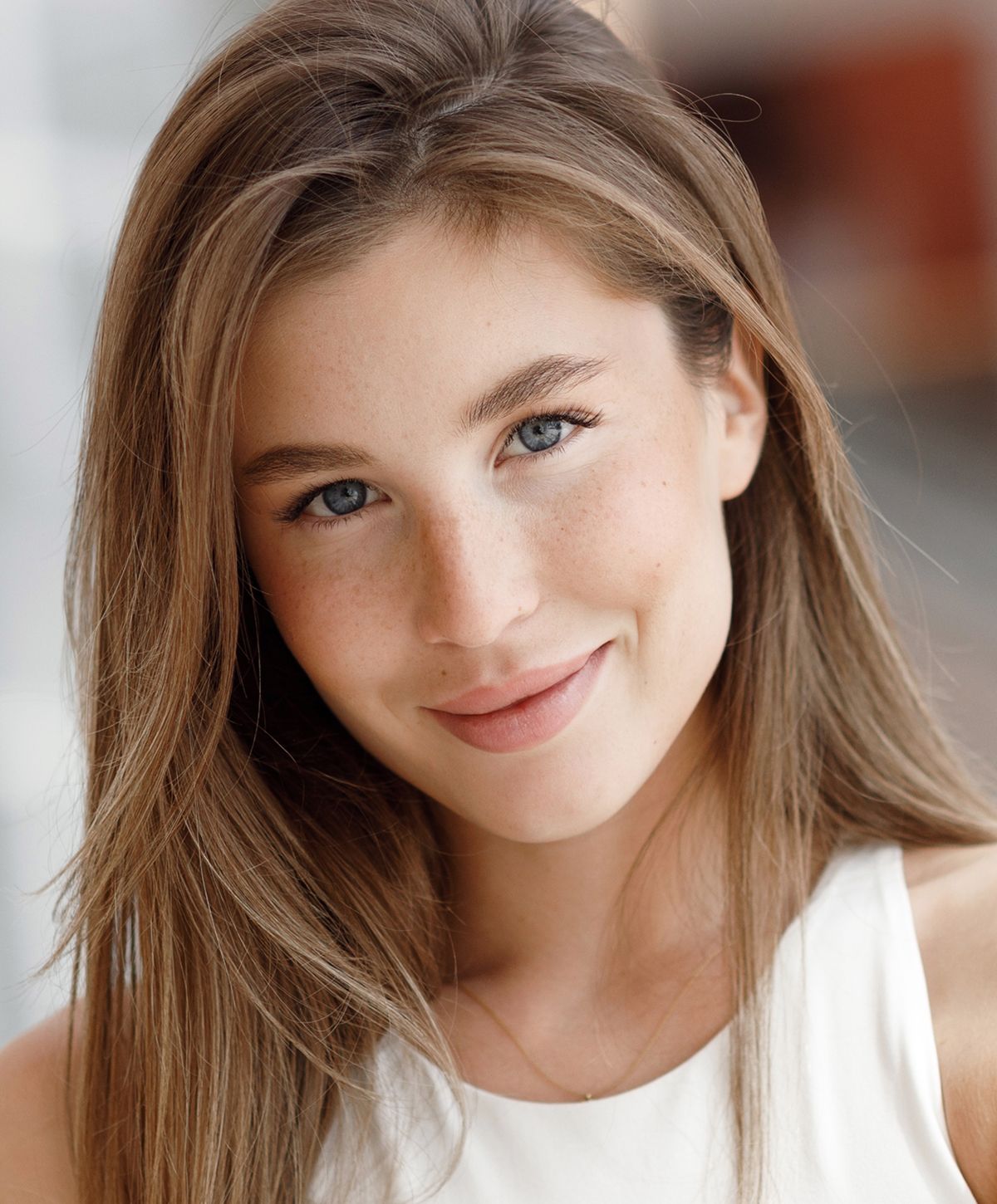 Smiling young woman with long, brown hair.