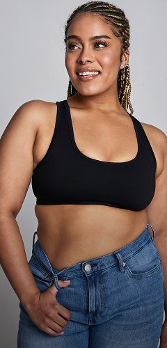 Smiling person in casual attire with braids.