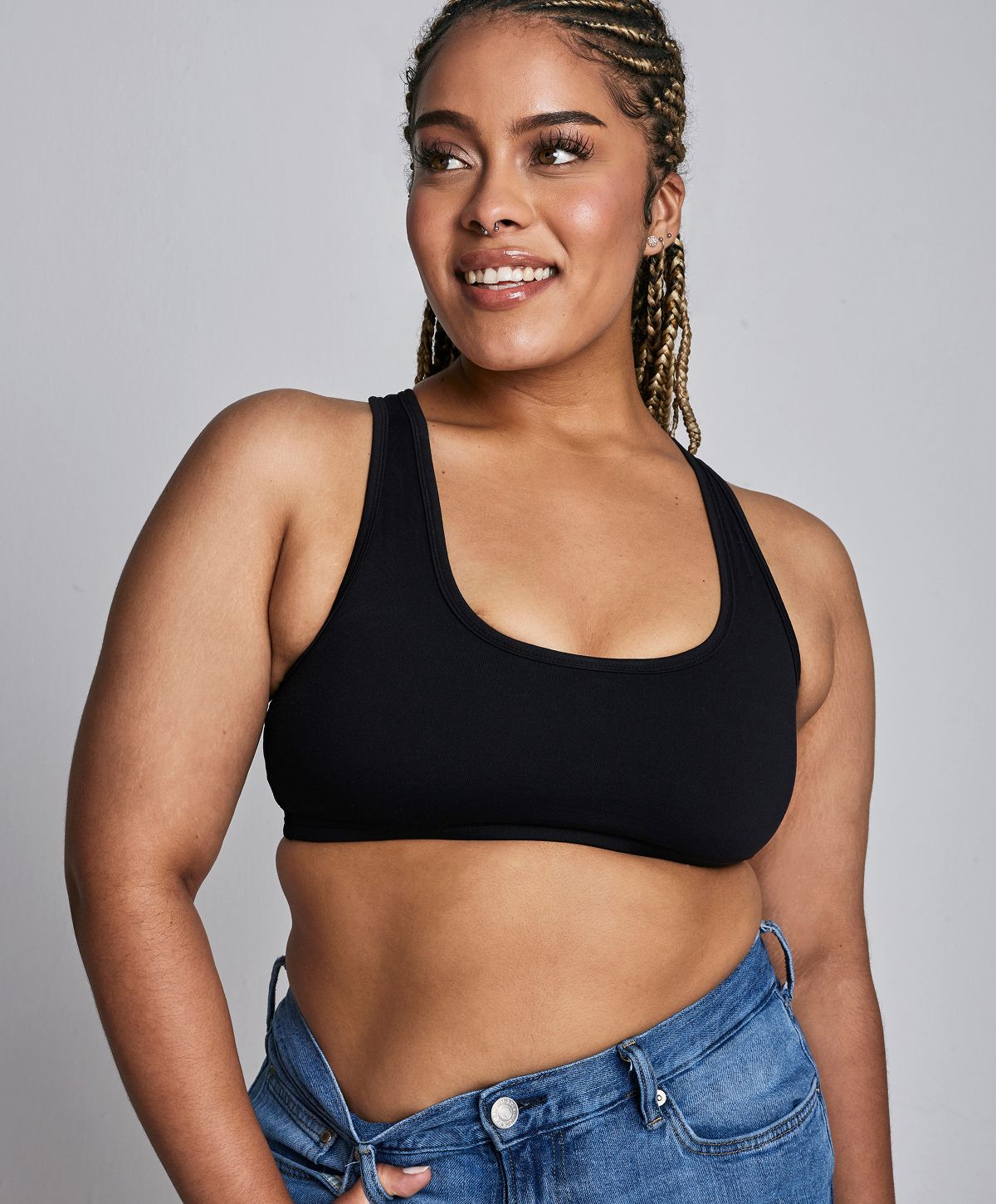 Woman smiling, holding oversized jeans, healthy lifestyle.