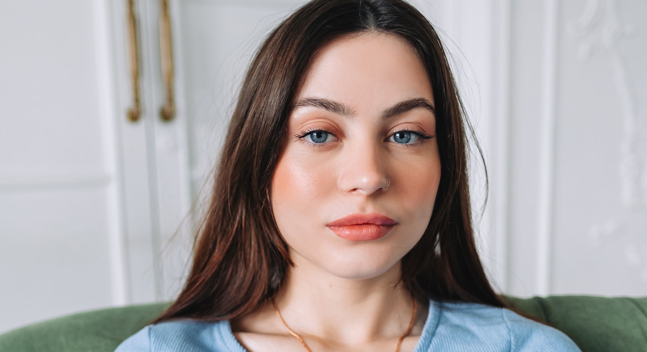 Young woman with long hair and blue eyes.