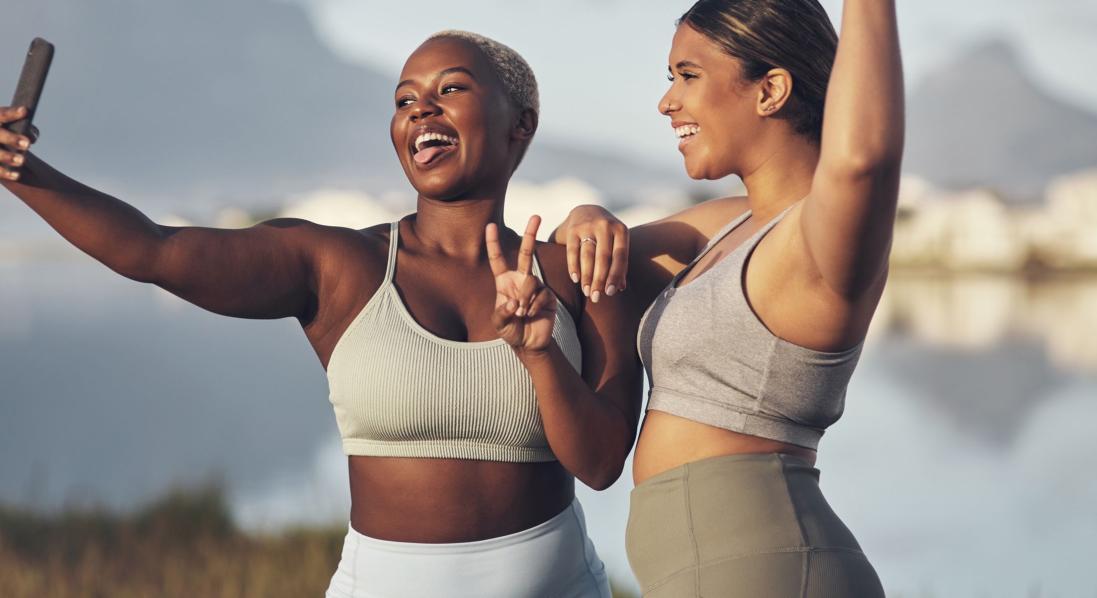 Two women taking a joyful selfie outdoors.