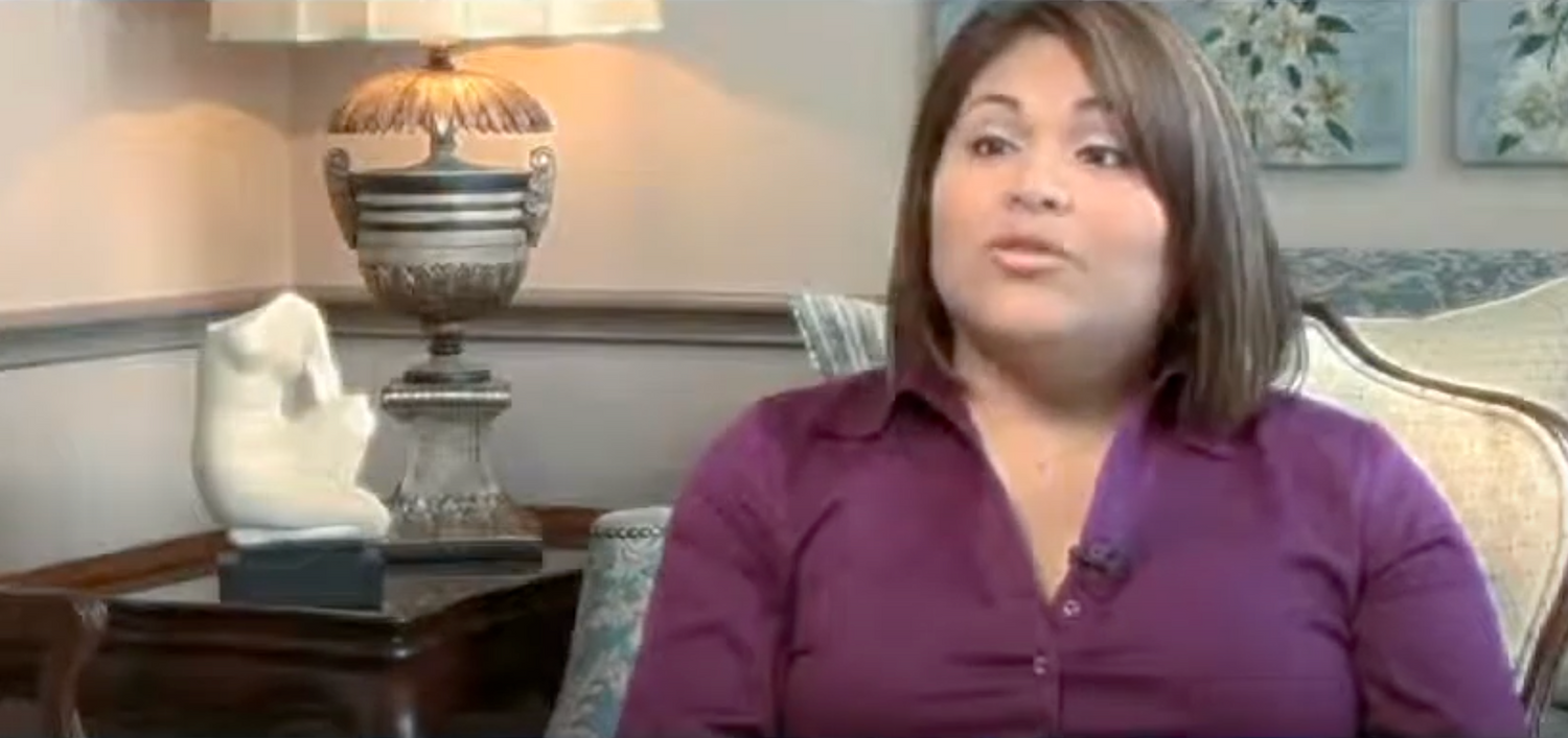 Woman speaking in a relaxed setting.