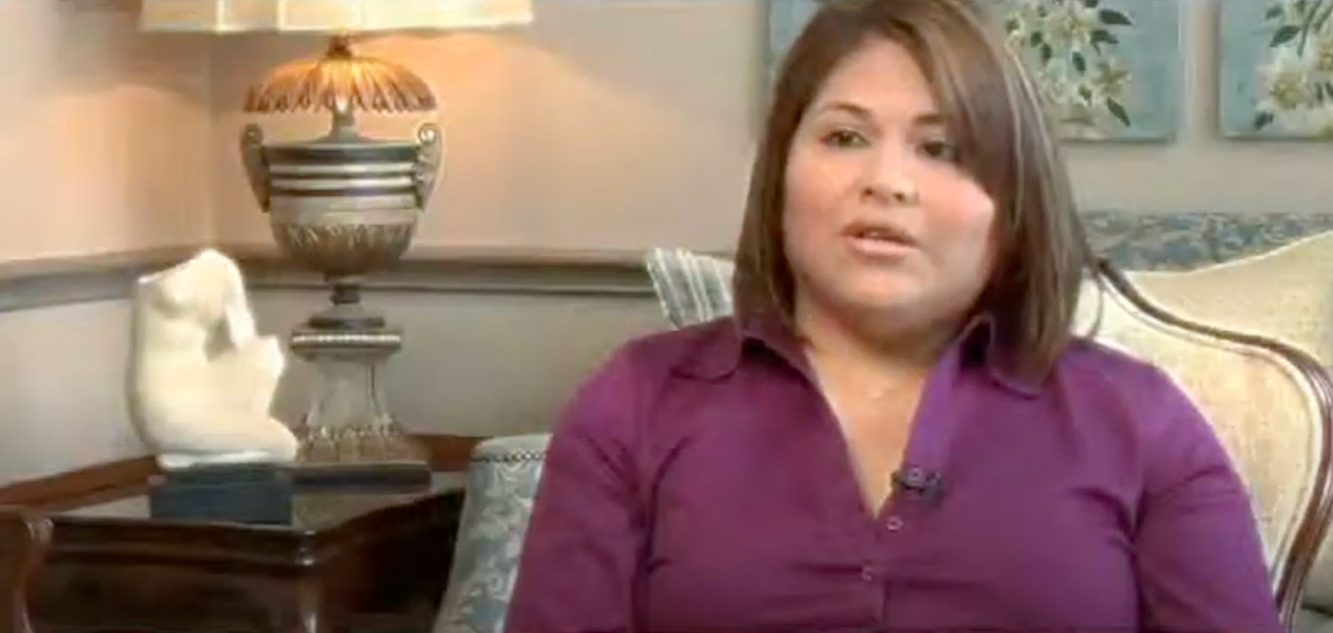 Woman speaking in a comfortable, indoor setting.