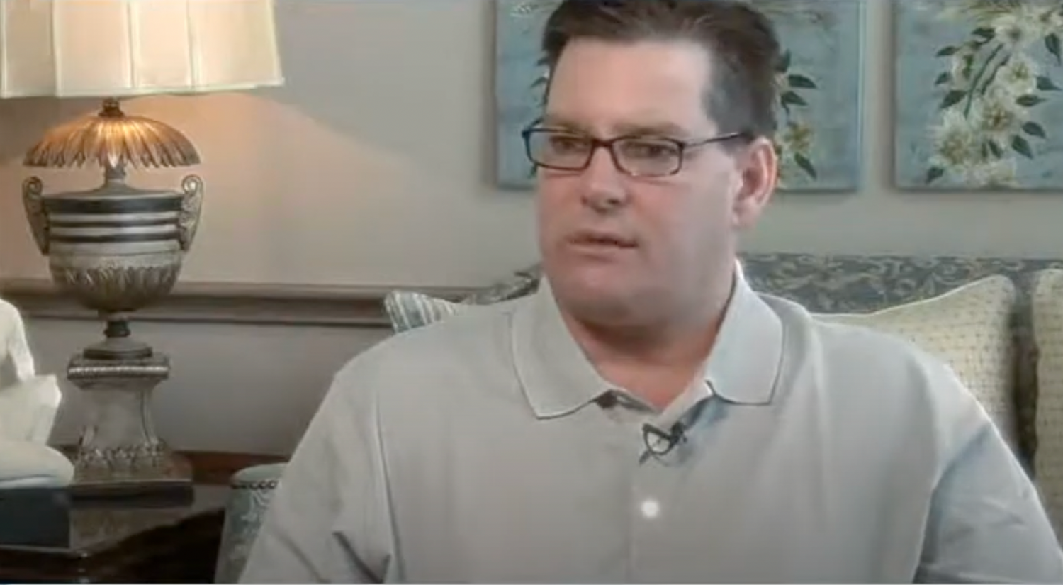 Person in a casual setting, talking during interview.