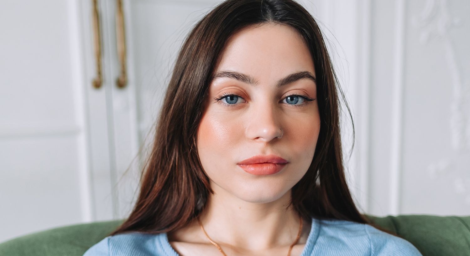 Young woman with long hair and blue eyes.