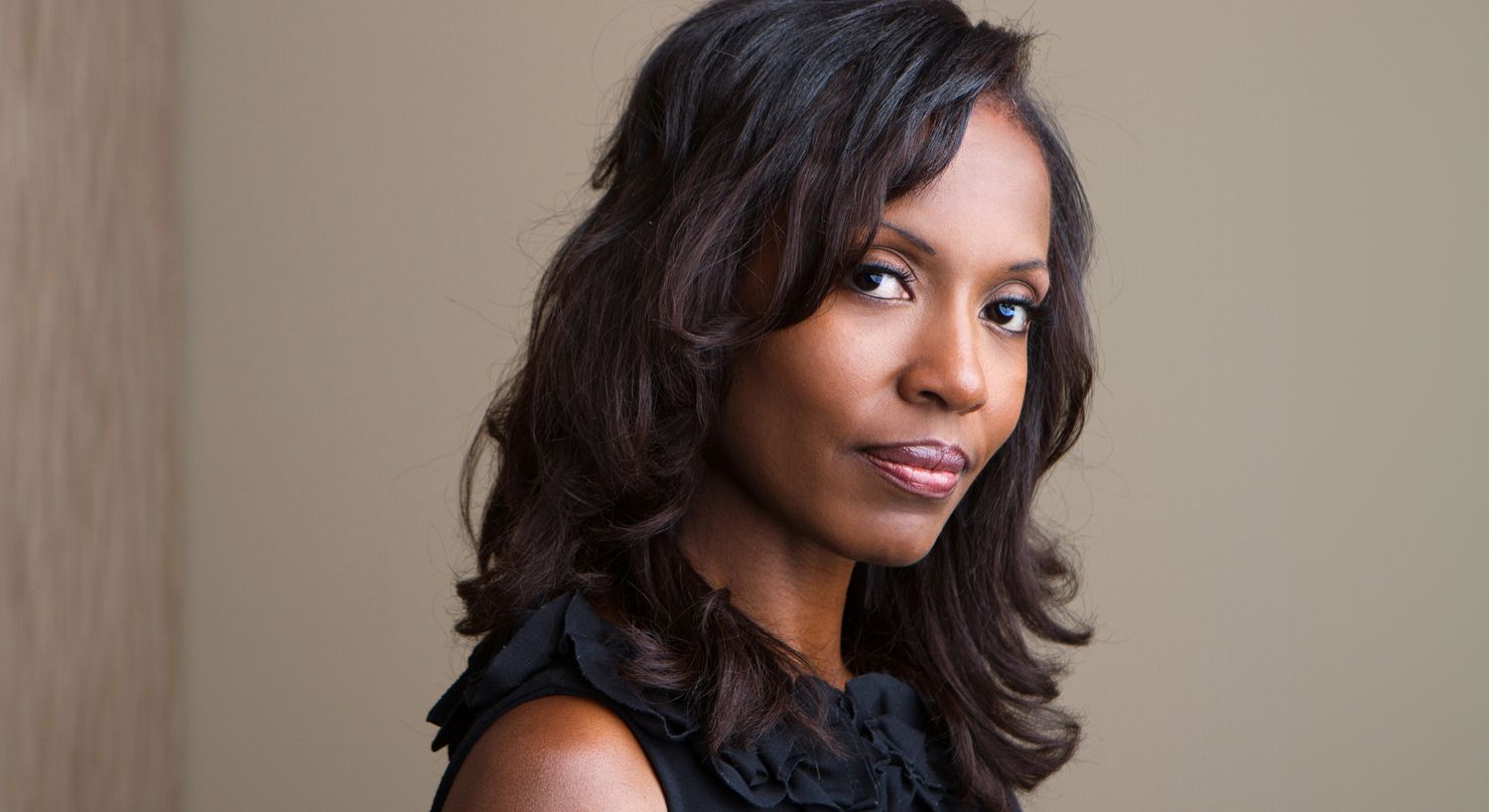 Portrait of a woman with long, wavy hair.