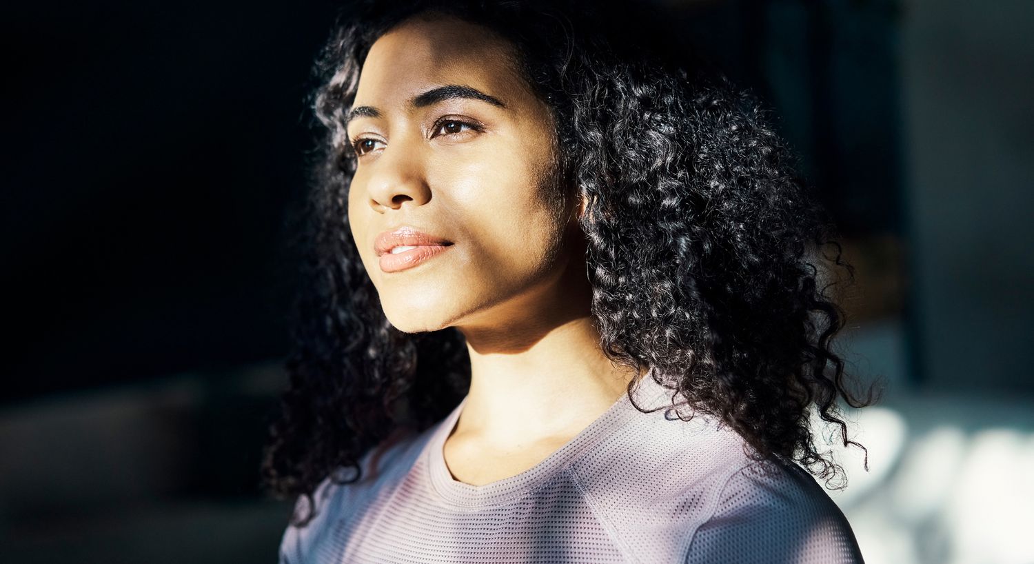 Woman looking thoughtfully with natural lighting.