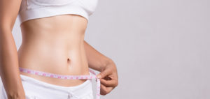 Woman deciding between a Tummy Tuck and Liposuction