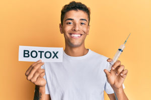 Handsome young man holding botox