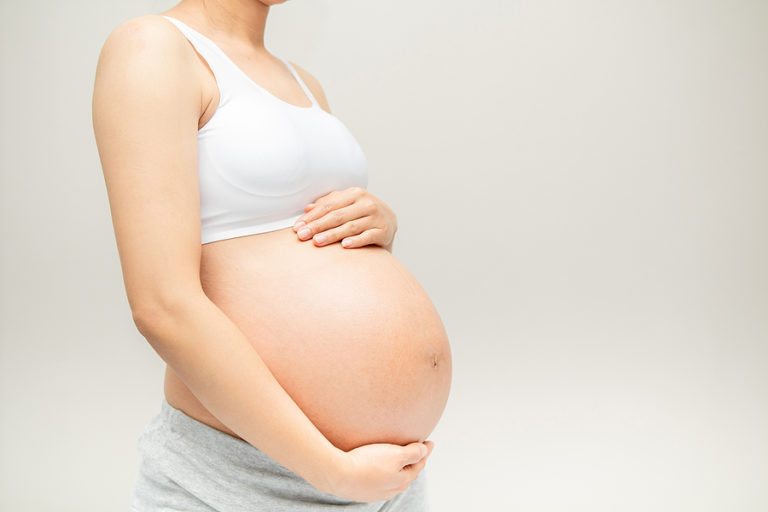 Pregnant woman after a tummy tuck