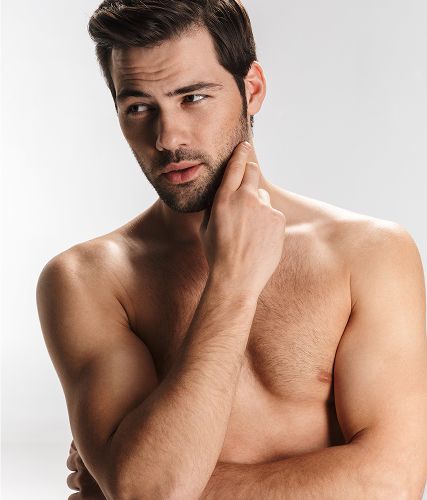 Bare-chested man with thoughtful expression.
