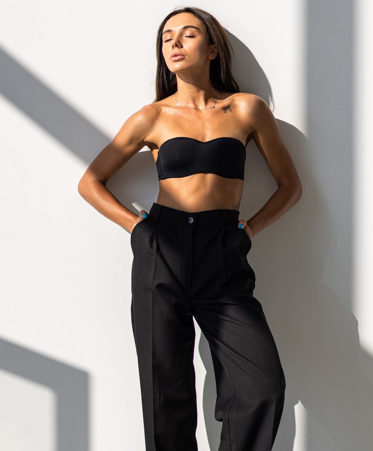Woman smiling, holding oversized jeans, healthy lifestyle.