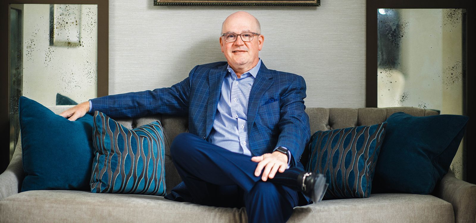 Woman smiling in a cozy chair setting.